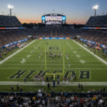 American football players on the field during a game showing real-time match duration
